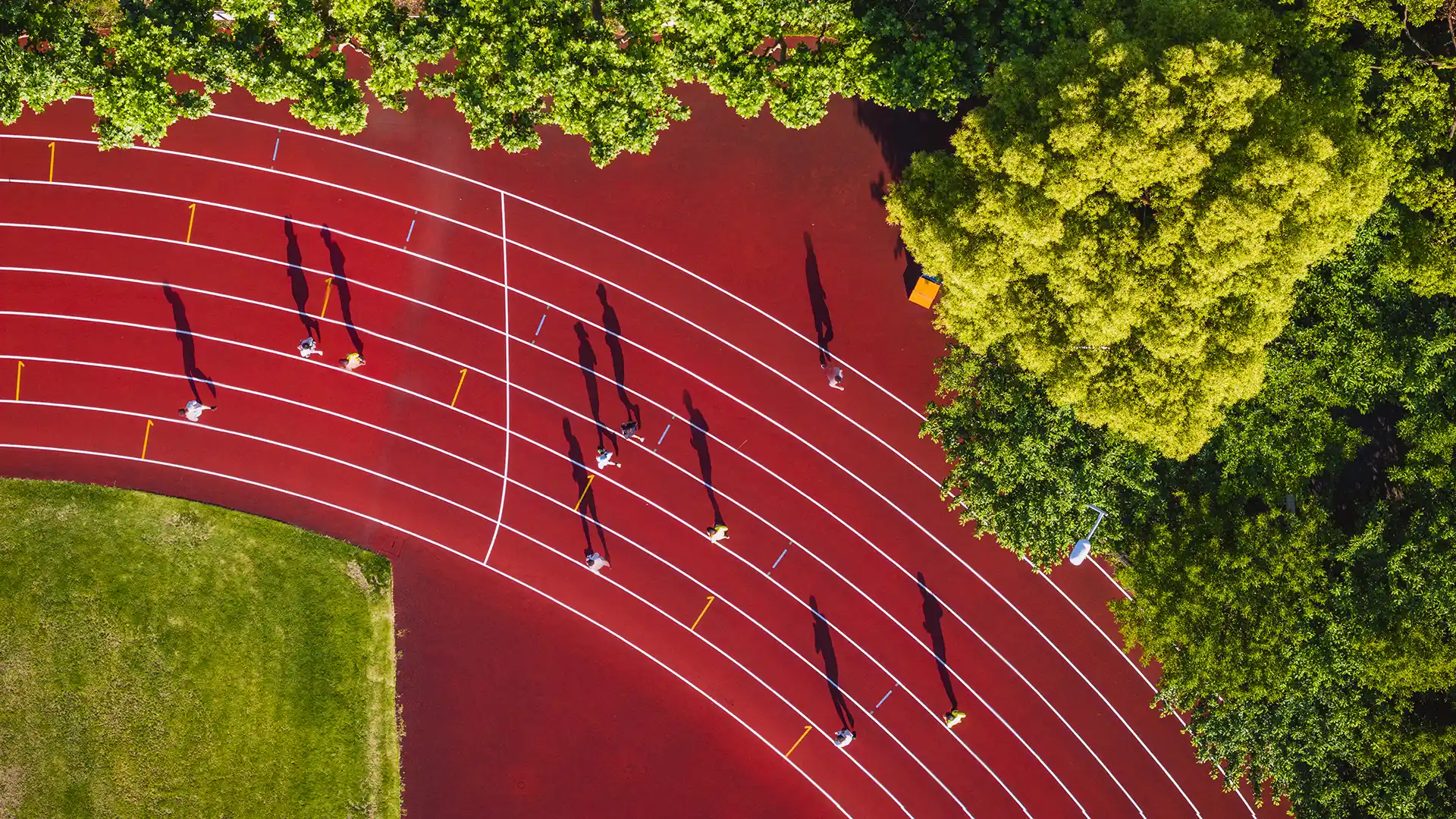 Aerial view of an athletics track with people running